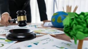Une main tenant un marteau de président. en arrière-plan, un globe terrestre en papier mâché.